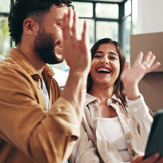 Happy clients celebrating success at Prestige Settlements, real estate settlement specialists.